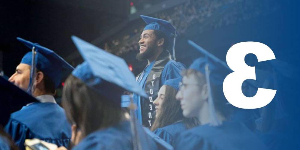 Student standing proudly during commencement - Designing Education for 21st Century